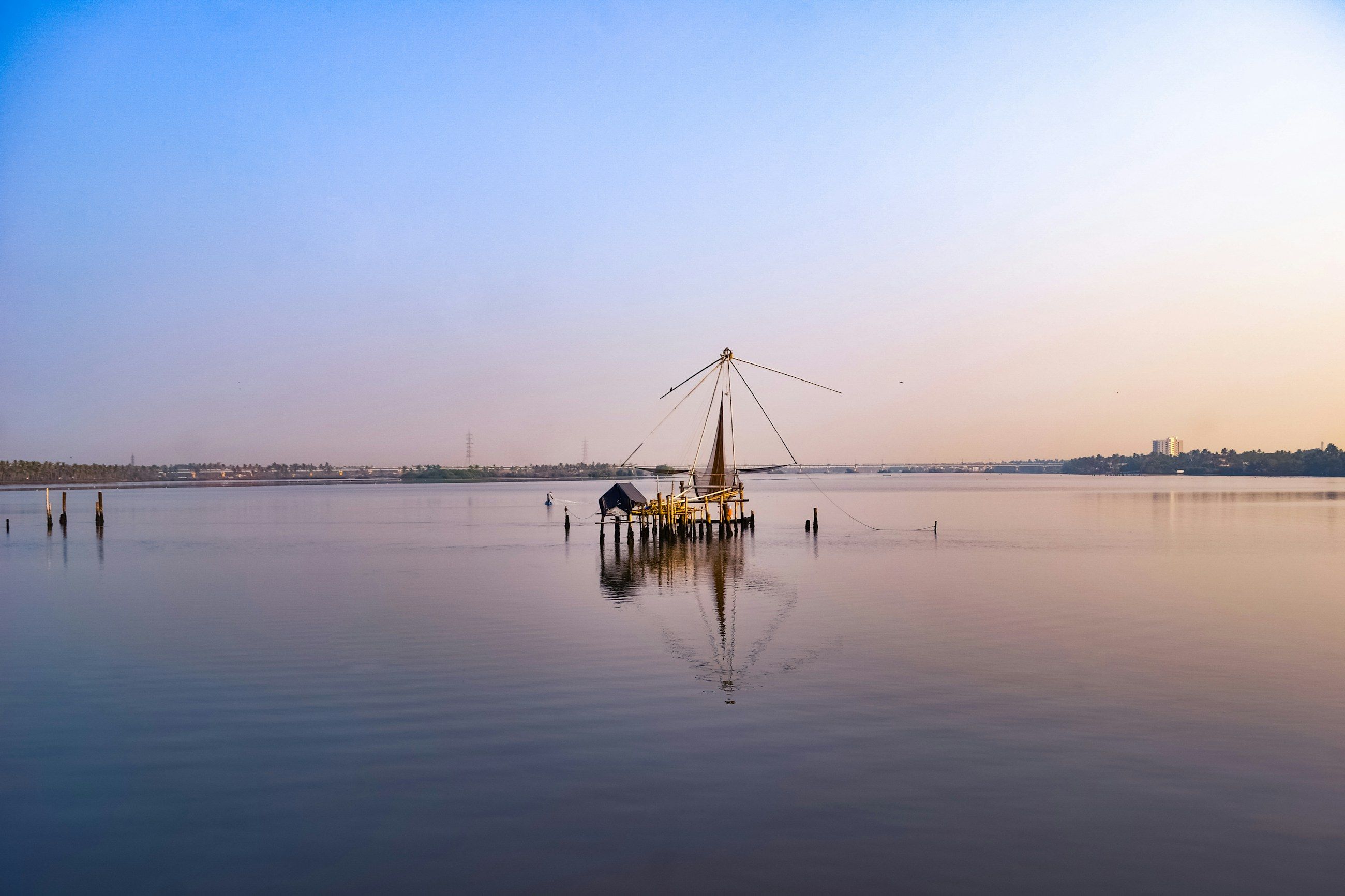 A Chinese fishing net at dawn on still water in Kochi